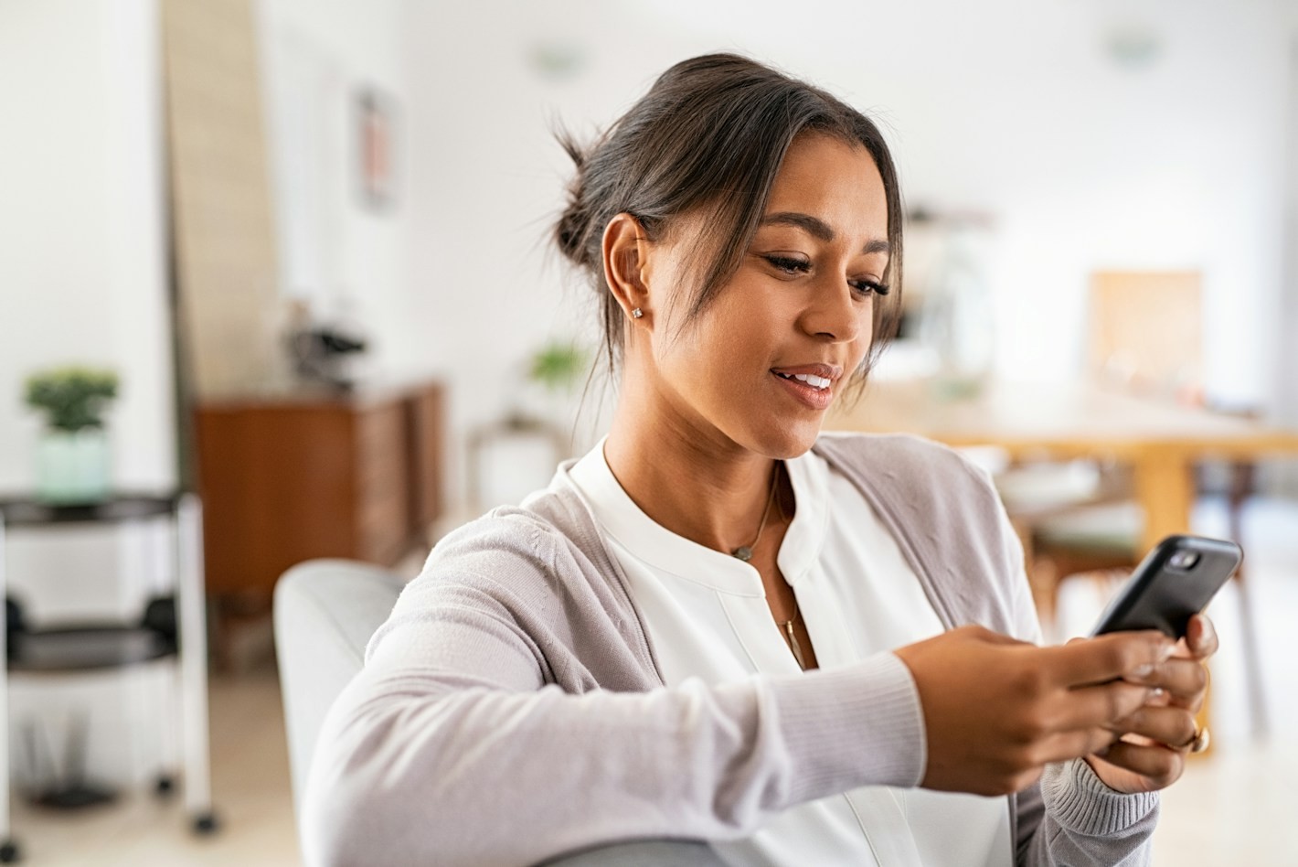 Woman using her phone at home